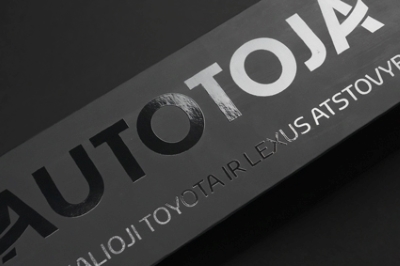 Glossy UV finish enhances the typography on black cardboard.